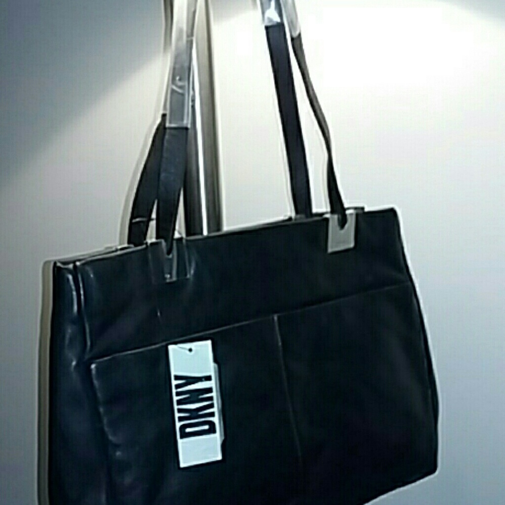 DKNY black leather purse. Two outside pockets. New